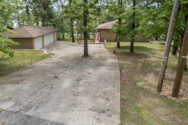 24311 Raintree Ln, Shell Knob, MO 65747 - view of yard with a detached garage, view of scattered trees, driveway, and an outdoor structure