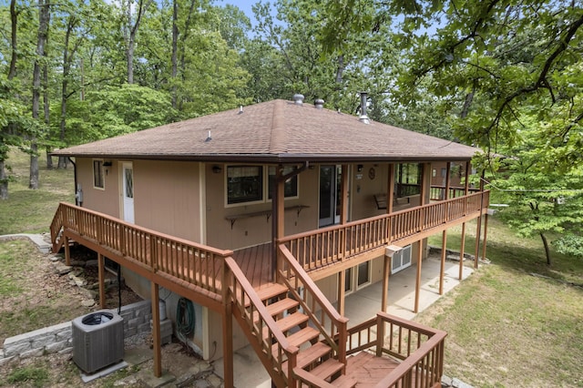 24311 Raintree Ln, Shell Knob, MO 65747 - back of property with central air condition unit, a wooden deck, a shingled roof, a patio area, and a lawn