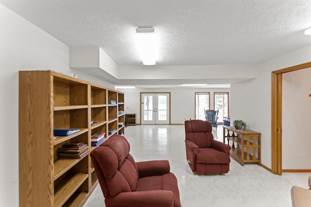 24311 Raintree Ln, Shell Knob, MO 65747 - living area with a textured ceiling, french doors, and baseboards