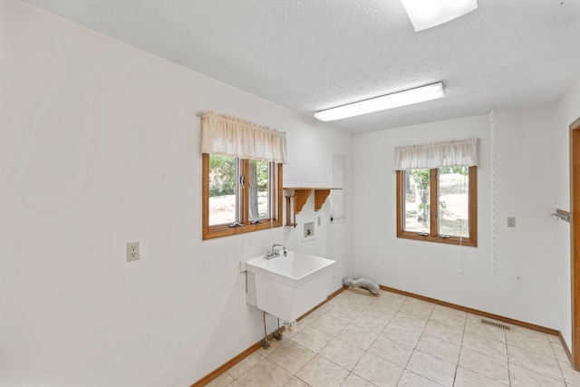 24311 Raintree Ln, Shell Knob, MO 65747 - washroom with hookup for a washing machine, a textured ceiling, and baseboards