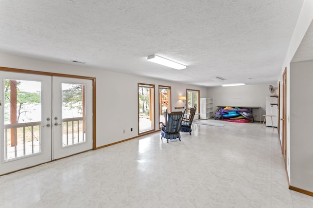 24311 Raintree Ln, Shell Knob, MO 65747 - sitting room with french doors, a textured ceiling, baseboards, and tile patterned floors