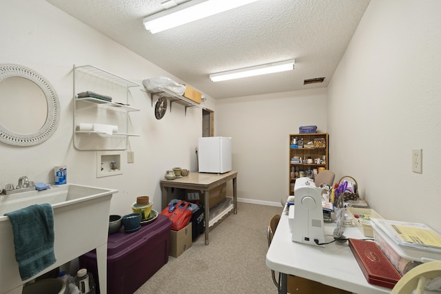 carpeted office with visible vents and a textured ceiling