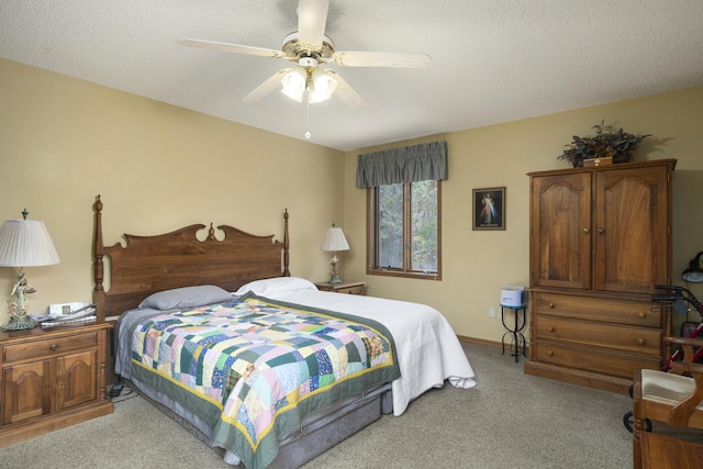 bedroom with ceiling fan, carpet floors, a textured ceiling, and baseboards