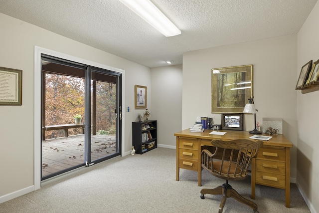 office with carpet, baseboards, and a textured ceiling