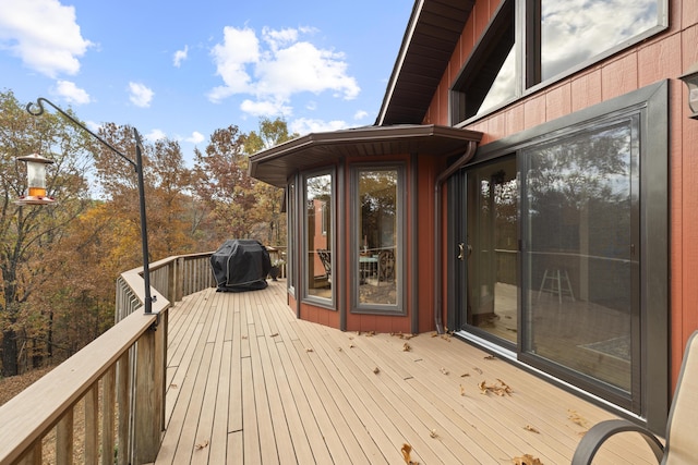 wooden deck featuring a grill