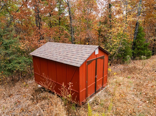 view of shed featuring a forest view