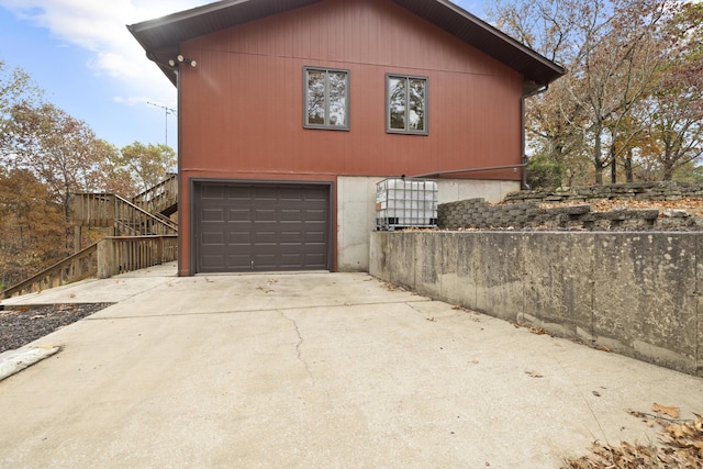 view of home's exterior with driveway and stairway