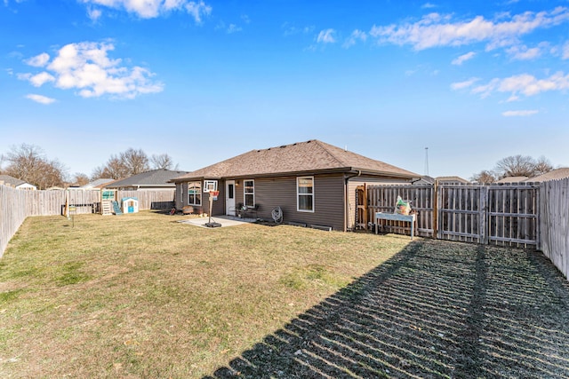 back of house with a patio area, a fenced backyard, a lawn, and roof with shingles