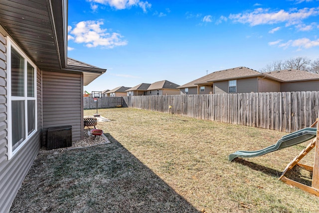 view of yard with a fenced backyard and a residential view