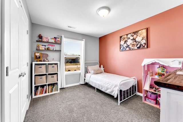 carpeted bedroom featuring visible vents and baseboards