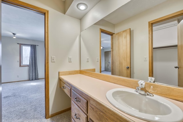 bathroom with vanity and baseboards