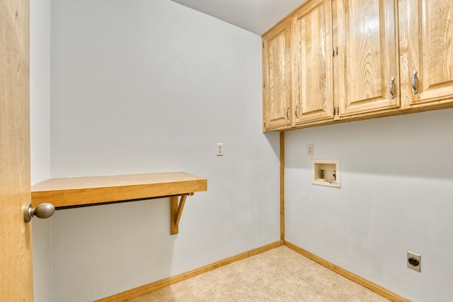 clothes washing area with washer hookup, cabinet space, hookup for an electric dryer, and baseboards