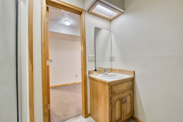 bathroom with vanity and baseboards