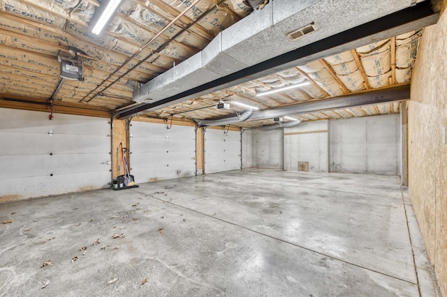 garage featuring visible vents and a garage door opener