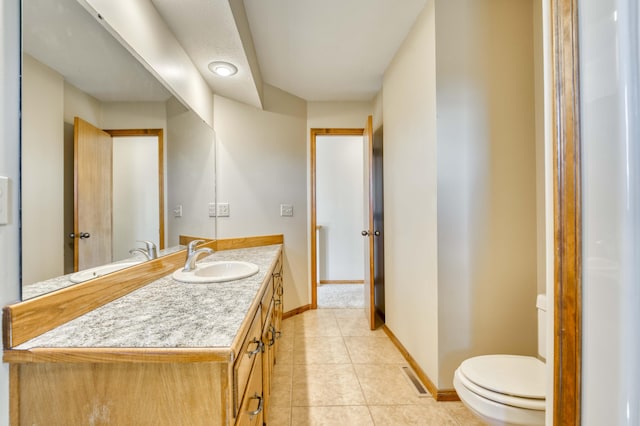 half bathroom with visible vents, toilet, vanity, tile patterned flooring, and baseboards