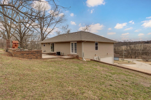 rear view of property featuring a patio, an attached garage, a playground, cooling unit, and a yard