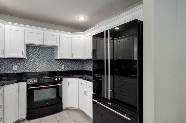 kitchen with black appliances, tile counters, and white cabinets