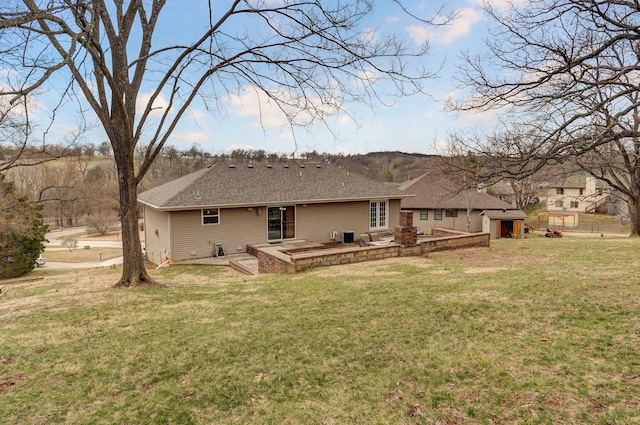 back of property featuring a yard