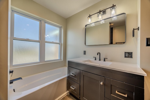 full bath featuring a garden tub and vanity