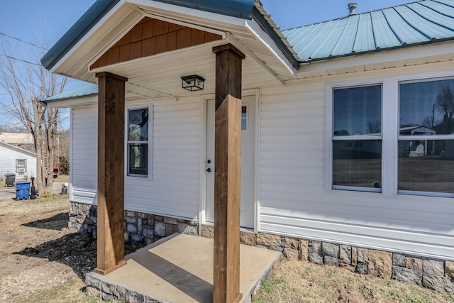 entrance to property featuring metal roof