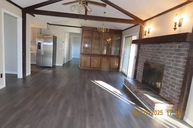 unfurnished living room with baseboards, lofted ceiling with beams, ceiling fan, dark wood-type flooring, and a brick fireplace