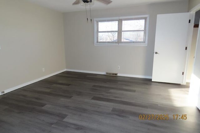 unfurnished room featuring visible vents, baseboards, and wood finished floors