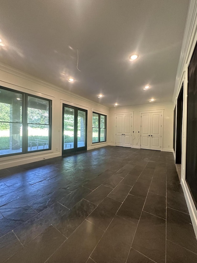 empty room featuring recessed lighting, french doors, crown molding, and baseboards