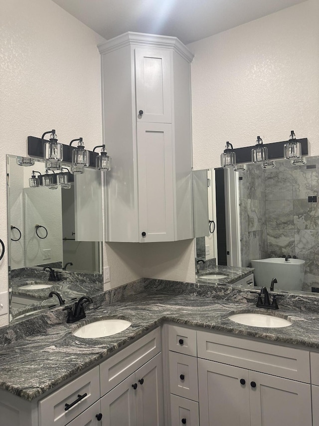 bathroom featuring double vanity and a sink