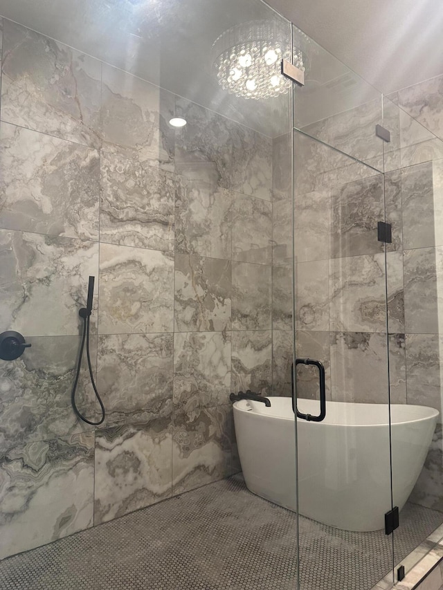 full bathroom featuring a stall shower, a soaking tub, and tile walls