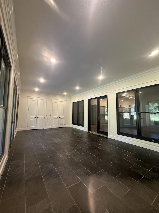 empty room featuring baseboards and ornamental molding