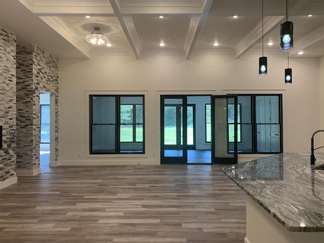 interior space featuring recessed lighting, ornamental molding, wood finished floors, coffered ceiling, and beamed ceiling