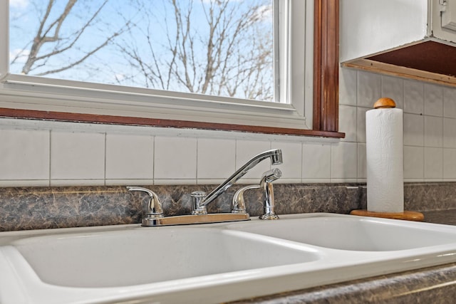 interior details with white cabinets and a sink