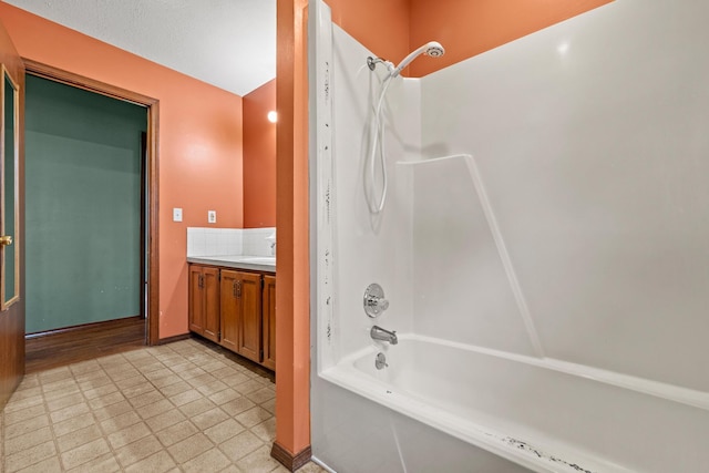 full bathroom with vanity, tile patterned floors, baseboards, and shower / bathtub combination