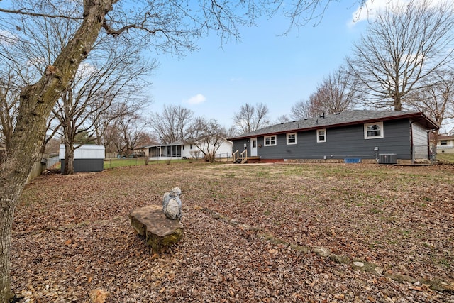 exterior space featuring central air condition unit, a storage shed, and an outdoor structure