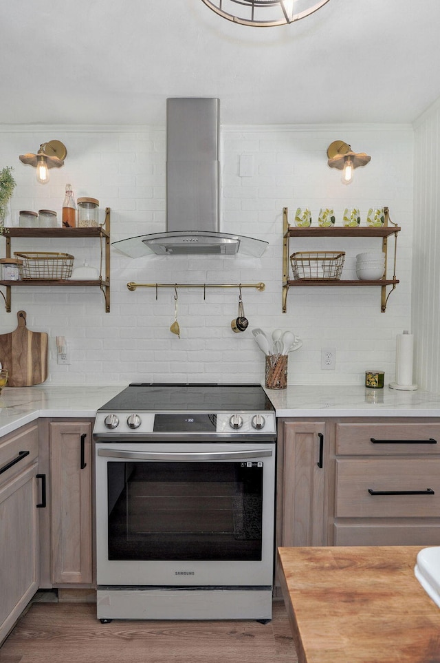 kitchen with stainless steel electric range, wood finished floors, wall chimney exhaust hood, and open shelves