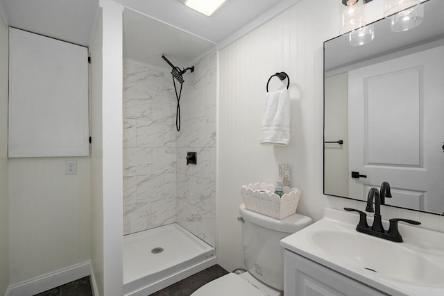 bathroom with toilet, a stall shower, and vanity