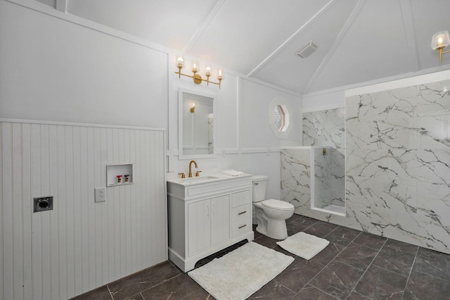 bathroom featuring a wainscoted wall, toilet, marble finish floor, a marble finish shower, and vaulted ceiling