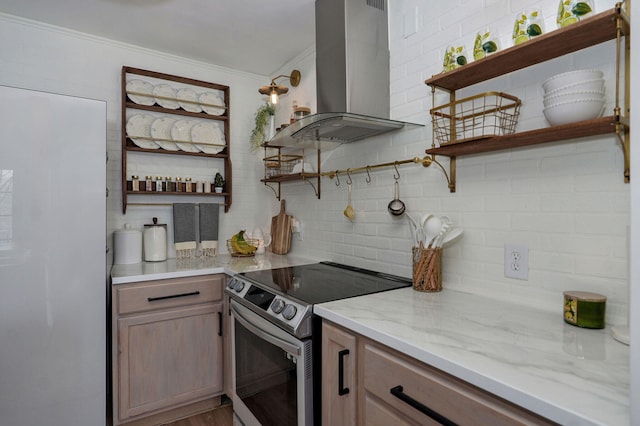 kitchen with open shelves, stainless steel electric stove, island exhaust hood, freestanding refrigerator, and decorative backsplash