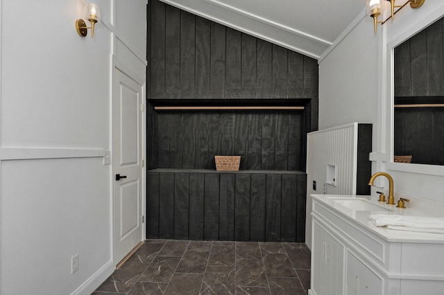 bathroom with vanity, vaulted ceiling, and marble finish floor