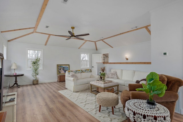 living area with visible vents, ceiling fan, lofted ceiling, and wood finished floors