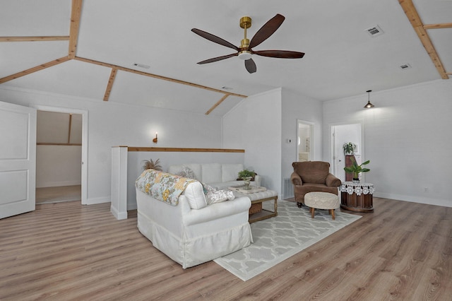 living area featuring visible vents, lofted ceiling, and wood finished floors