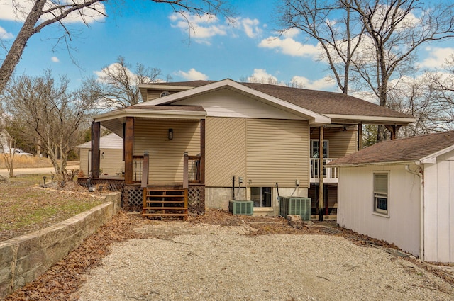 exterior space featuring central AC and roof with shingles