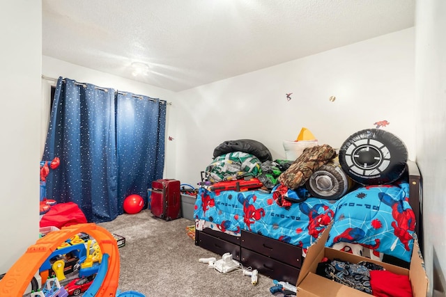 bedroom featuring carpet and a textured ceiling