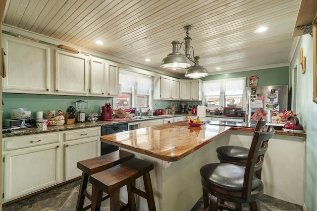 kitchen with black dishwasher, plenty of natural light, freestanding refrigerator, and a sink