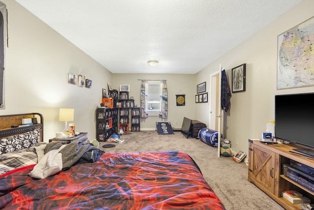 carpeted bedroom with baseboards and a textured ceiling