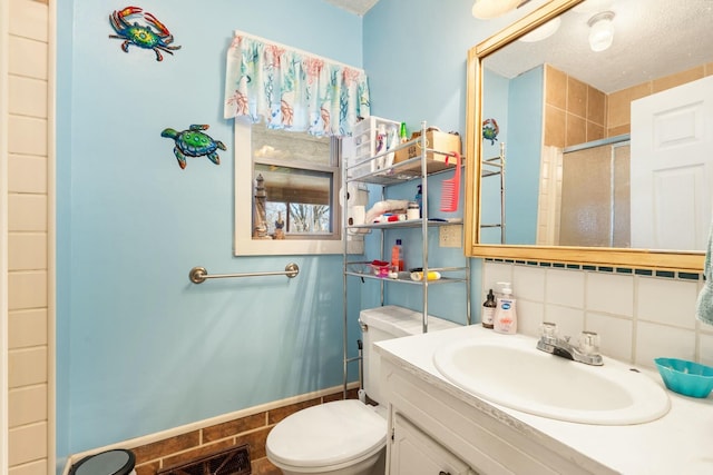 bathroom featuring vanity, visible vents, a shower stall, toilet, and tasteful backsplash