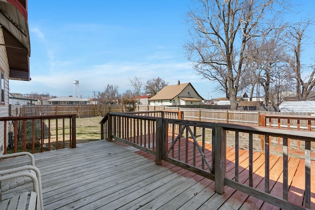 wooden deck with a fenced backyard and a residential view