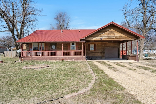 rustic home featuring driveway, covered porch, a front lawn, a carport, and metal roof