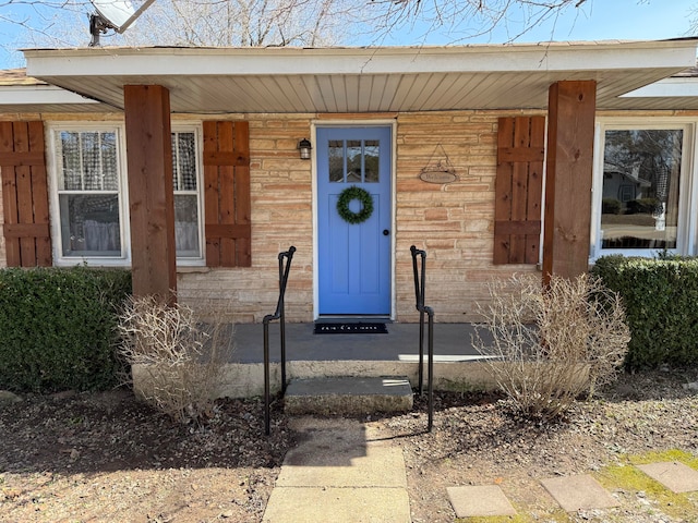 view of exterior entry with brick siding