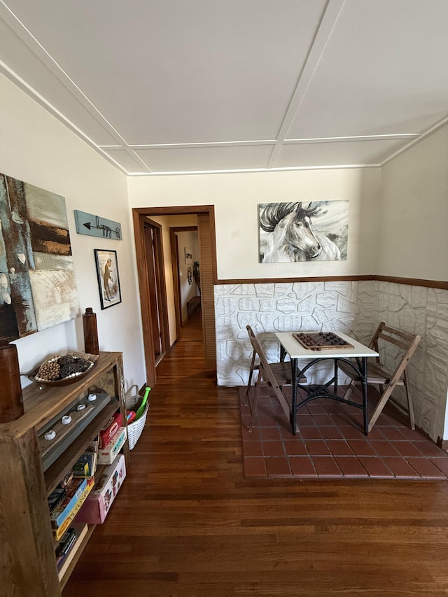 dining room with dark wood-type flooring and wainscoting